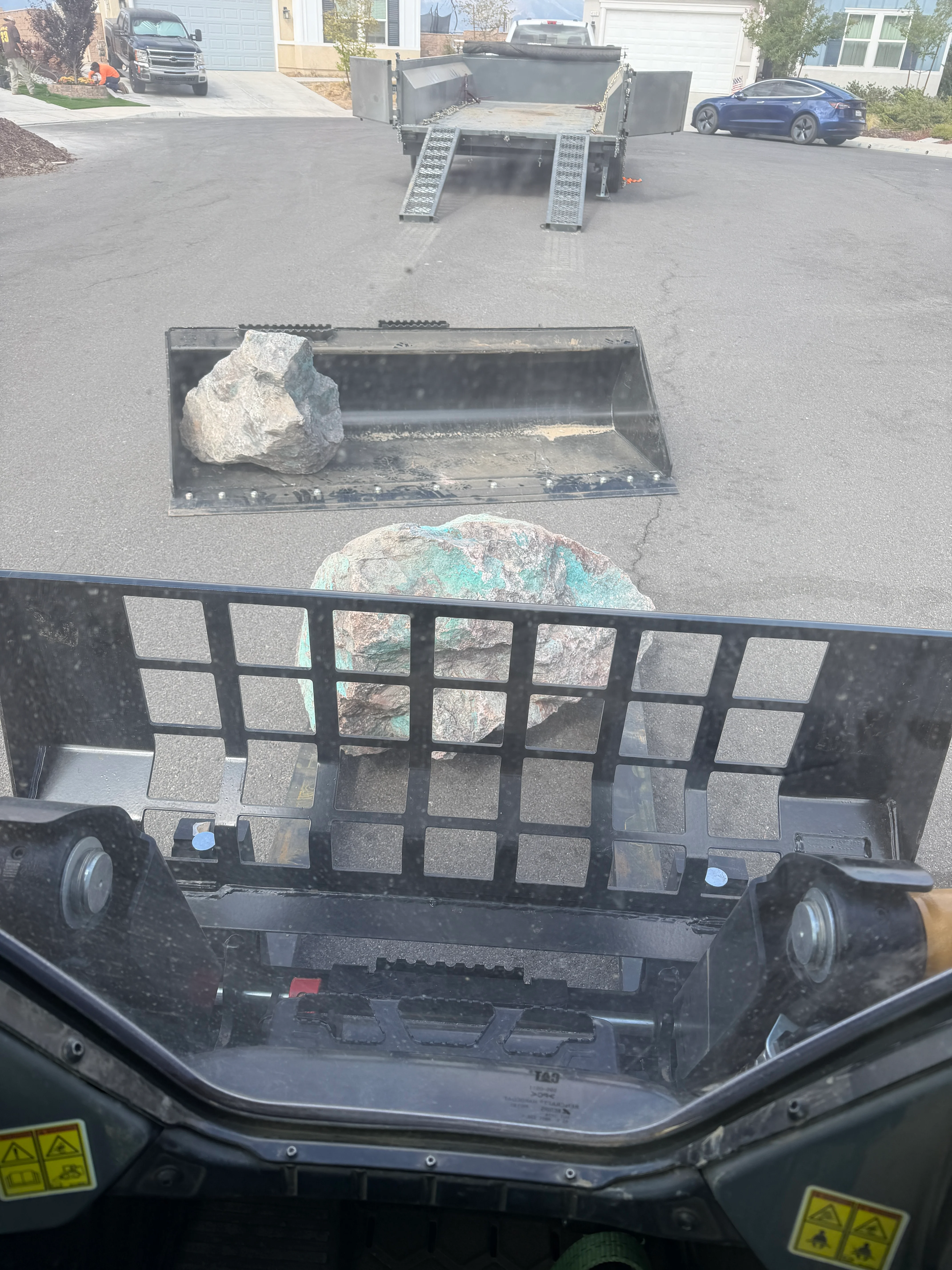Dump truck loaded with large boulders and rock debris during land clearing operation